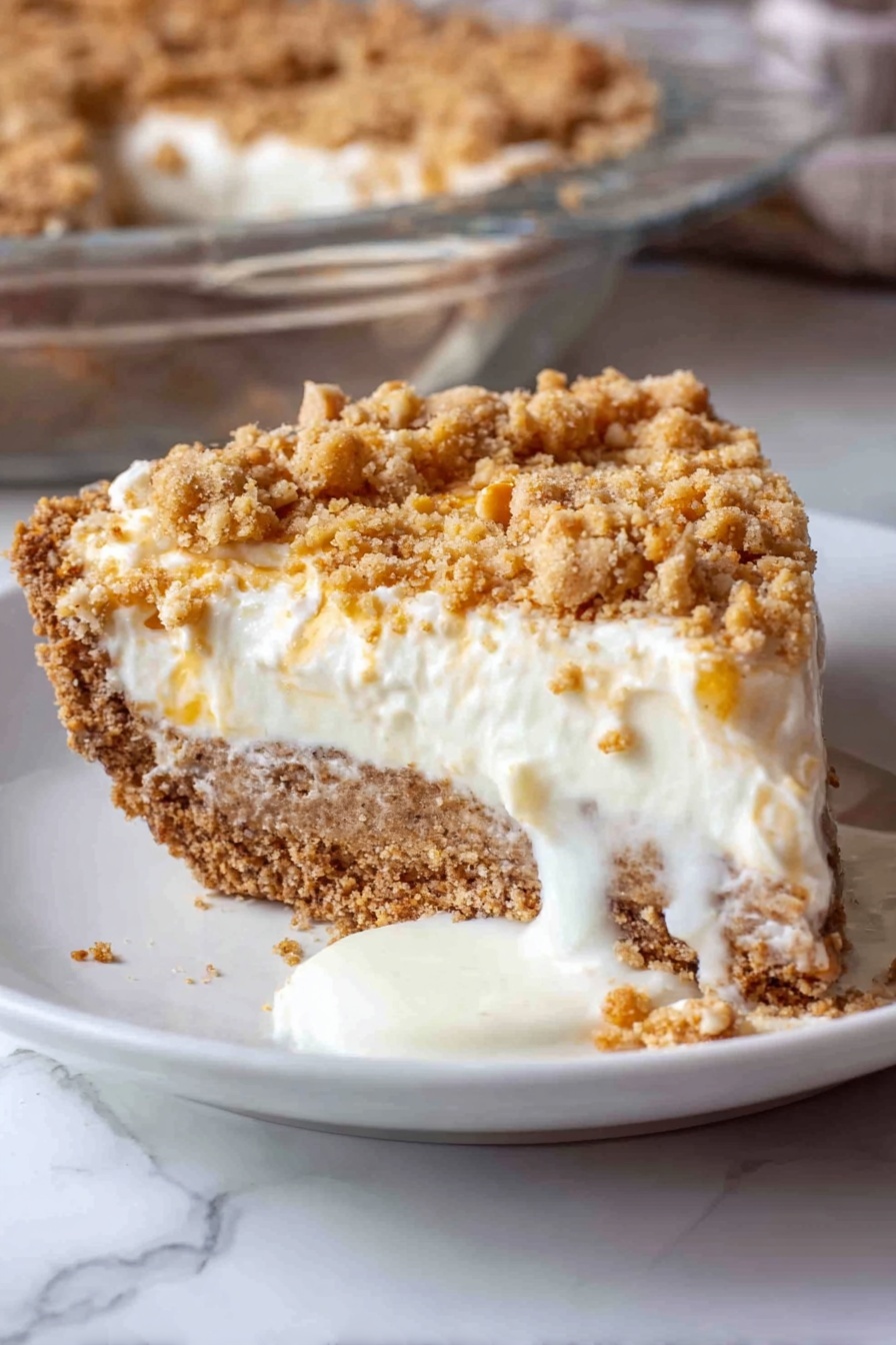 Angel Pecan Pie HoneySweet Pecan Pie Fluffy Pecan Pie Buttery Crust Pecan Pie - A close-up view of a thick, light brown crust with cracks, forming the base layer in a clear glass pie dish, on a white marbled surface. On top of the crust, a fluffy, white cream layer is being spread evenly, poured from a bowl using a blue spatula held by a woman's hand. The cream is soft and smooth, with gentle folds as it lands on the crust, creating a thick second layer. The background shows a blurred maroon fabric. Photo taken with an iphone --ar 2:3 --v 7