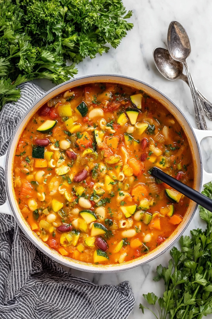 Easy Minestrone Soup, hearty vegetable soup, quick healthy soup, budget-friendly soup recipe, comforting vegetarian soup - A close-up view of a white pot filled with a thick vegetable soup, showing many soft, colorful chunks. The soup has a reddish-orange broth and contains yellow squash, green zucchini slices, orange carrots, celery, red kidney beans, and small shell pasta. A dark wooden ladle lifts a scoop of soup with mixed vegetables and shells, highlighting the varied textures and colors. The pot sits on a white marbled surface with some green herbs blurred in the background, and a woman's hand holding the ladle is slightly visible. Photo taken with an iphone --ar 2:3 --v 7