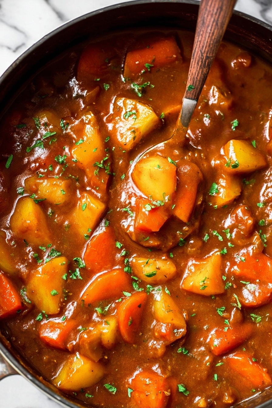 Vegan Irish Stew, hearty vegan stew, plant-based Irish stew, vegan comfort food, Irish stew with vegetables - The image shows a thick stew in a large pan filled with chunky vegetables including bright orange carrot slices and yellow potato pieces. The stew sauce is rich brown and glossy, spread evenly around the vegetables. Small green herb pieces sprinkle the top, adding a fresh contrast to the warm tones. A spoon sinks into the stew, lifting some of the colorful vegetables, making the texture appear smooth and hearty. The background surface is a white marbled texture. photo taken with an iphone --ar 2:3 --v 7